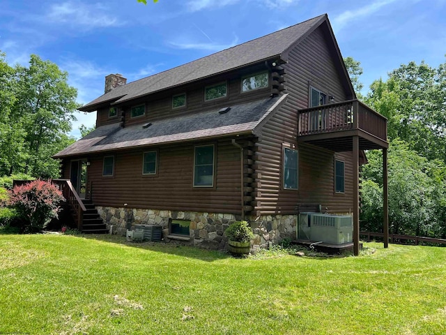 back of house with central AC and a yard