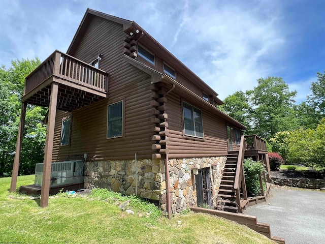 view of side of property with a lawn and a deck