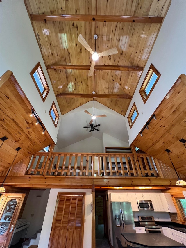 details featuring beamed ceiling, wooden ceiling, decorative light fixtures, and appliances with stainless steel finishes