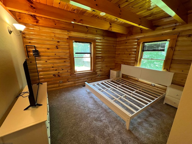 bedroom with multiple windows, log walls, beamed ceiling, and dark colored carpet