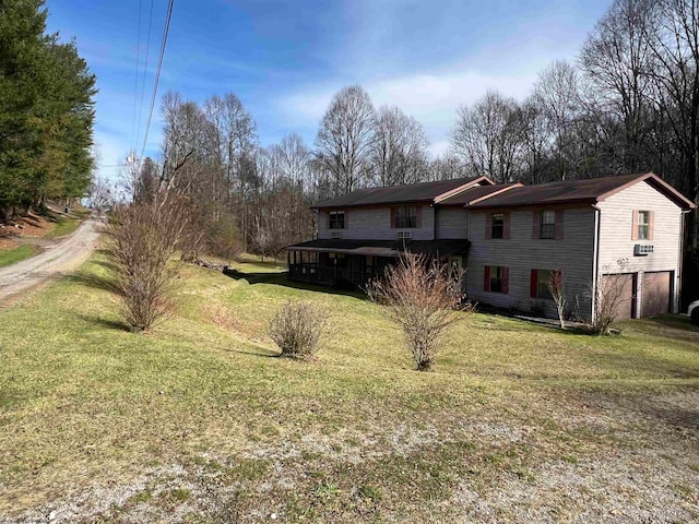 exterior space featuring a lawn and a garage