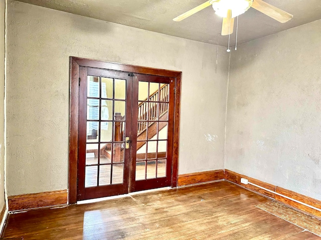 entryway featuring ceiling fan, french doors, and wood-type flooring