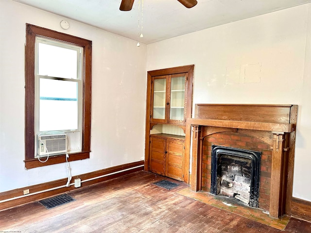 unfurnished living room with hardwood / wood-style flooring, ceiling fan, and cooling unit