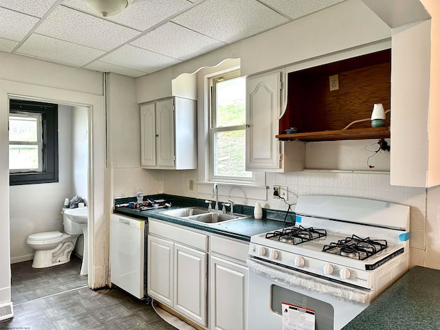 kitchen featuring white cabinetry, sink, a drop ceiling, and white appliances