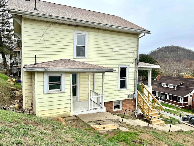 back of property featuring a mountain view