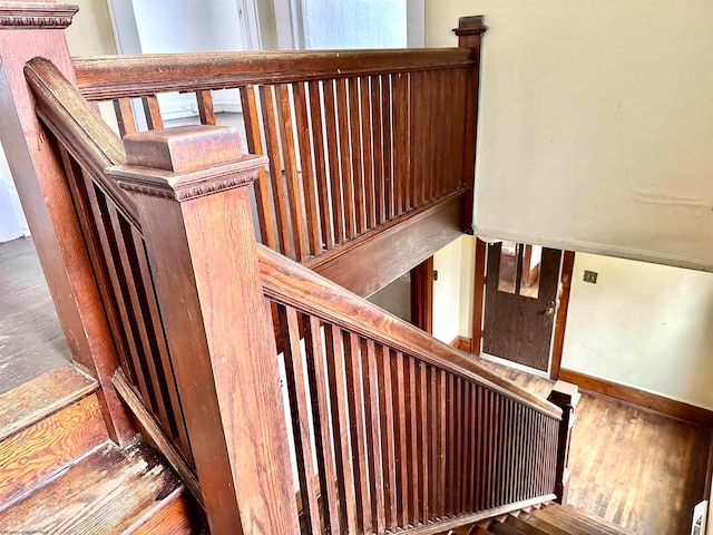 stairs featuring wood-type flooring