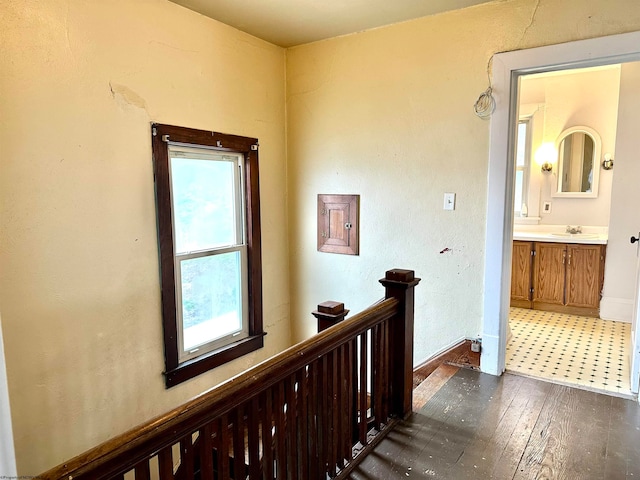 hall featuring dark wood-type flooring and sink