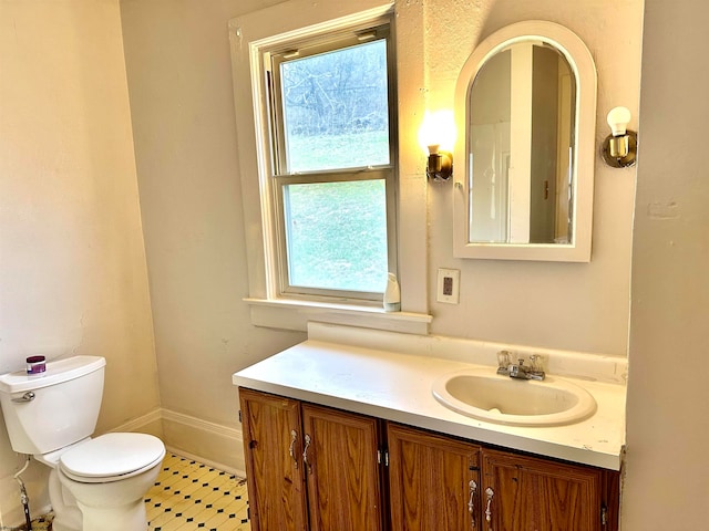 bathroom with tile patterned floors, vanity, and toilet