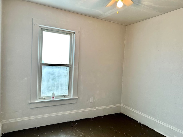 unfurnished room with ceiling fan and dark hardwood / wood-style flooring