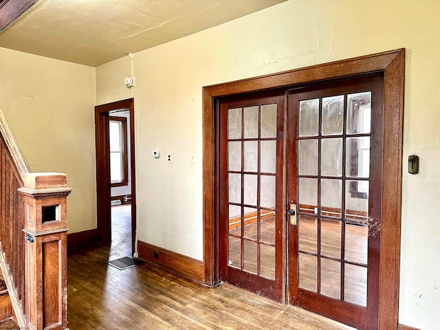 interior space with french doors and hardwood / wood-style flooring