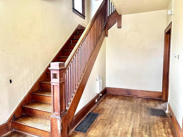 stairs with hardwood / wood-style floors