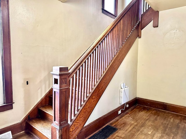 stairs featuring hardwood / wood-style floors