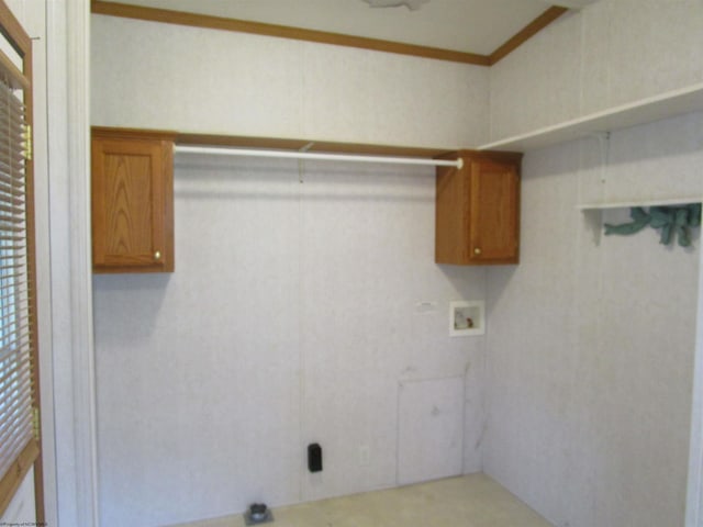 washroom featuring a wealth of natural light, cabinets, washer hookup, and ornamental molding