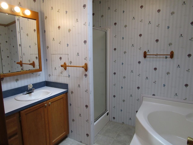 bathroom with tile patterned floors, vanity, and independent shower and bath