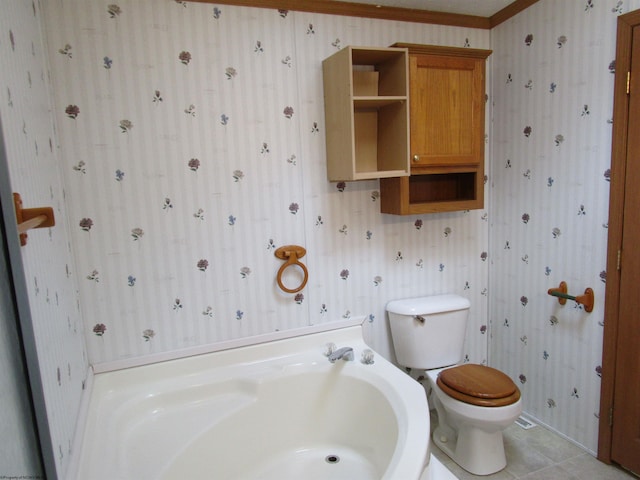 bathroom with toilet, tile patterned floors, a tub, and ornamental molding