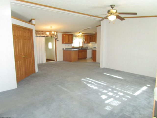 unfurnished living room featuring light carpet, ceiling fan with notable chandelier, and ornamental molding