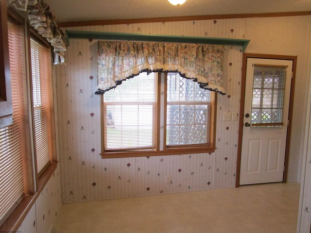 unfurnished room featuring carpet flooring, a textured ceiling, and vaulted ceiling