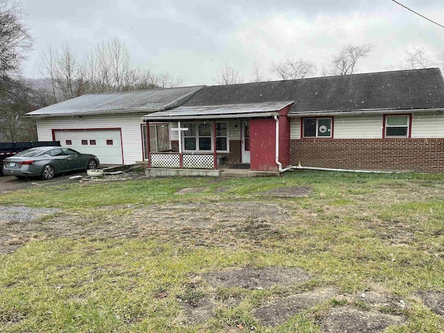 ranch-style house featuring covered porch and a garage