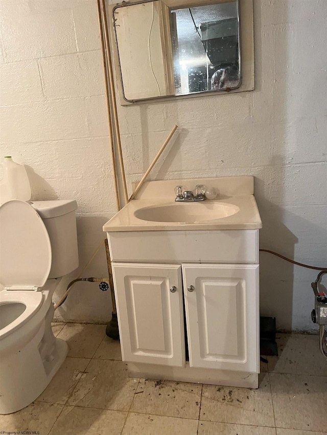 bathroom featuring tile patterned flooring, vanity, and toilet