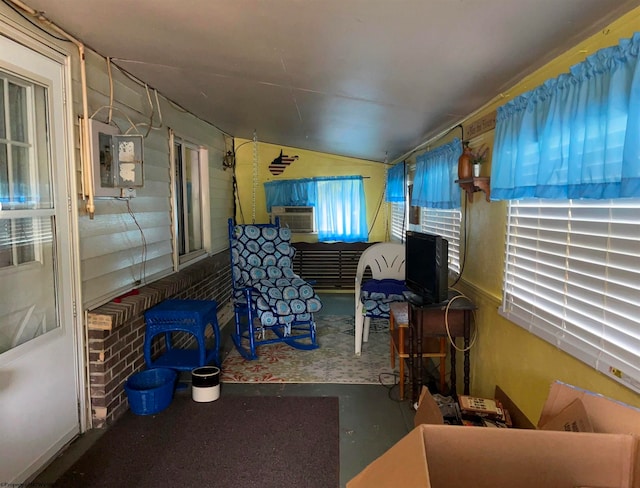 sunroom featuring electric panel and cooling unit