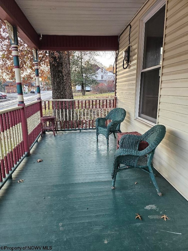 wooden terrace featuring covered porch