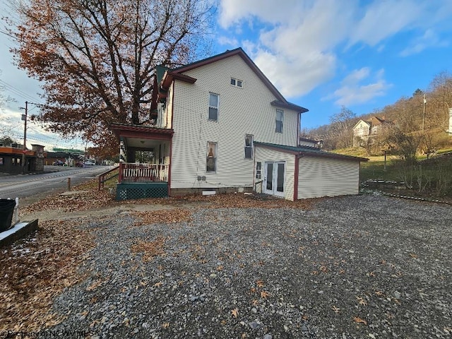 rear view of property featuring a porch