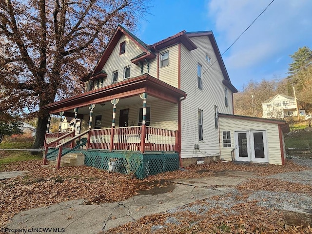 view of front of property featuring a porch and french doors