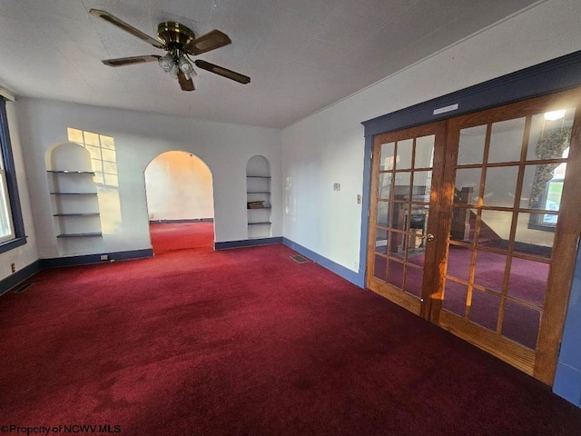 empty room featuring french doors, plenty of natural light, and ceiling fan