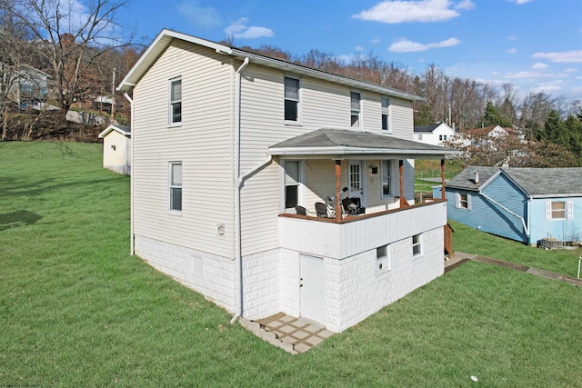 view of front facade with a porch, a front lawn, and an outdoor structure