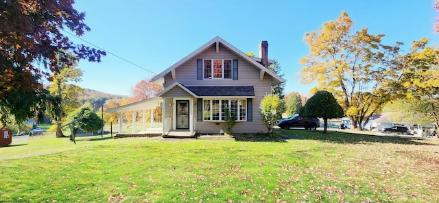 rear view of house with a yard