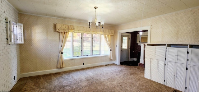 unfurnished dining area featuring a chandelier, carpet floors, and ornamental molding