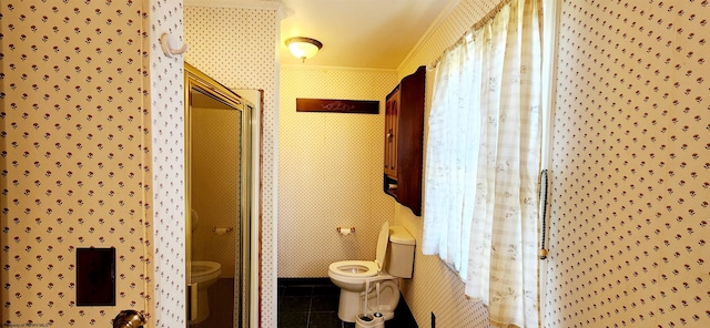 bathroom with tile patterned floors, toilet, crown molding, and walk in shower