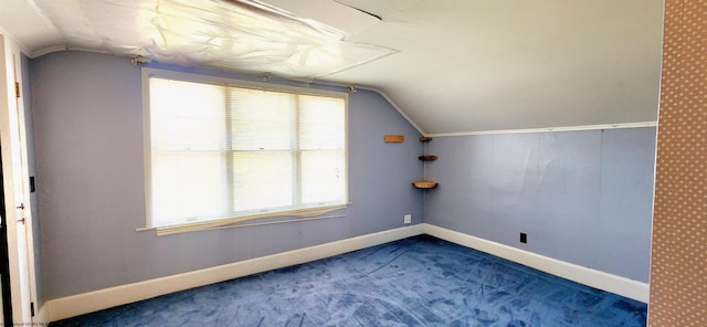 bonus room with carpet floors and lofted ceiling