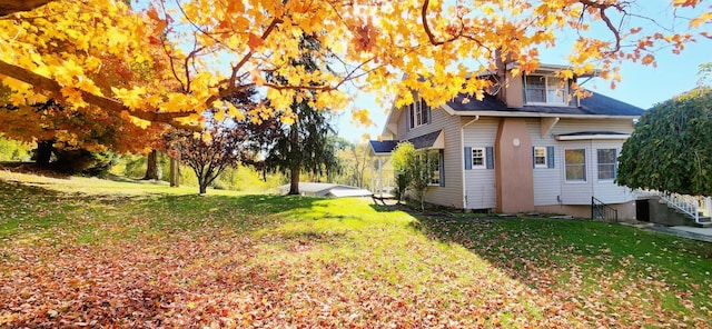 view of side of home with a lawn