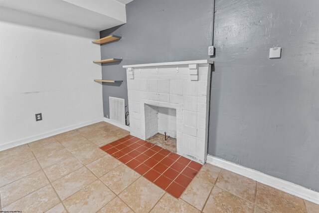 unfurnished living room with tile patterned flooring