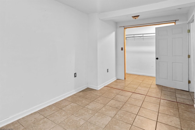 unfurnished bedroom featuring a closet and light tile patterned floors