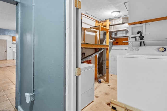 laundry room featuring light tile patterned floors and washer / dryer