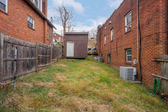 view of yard with cooling unit and a storage shed