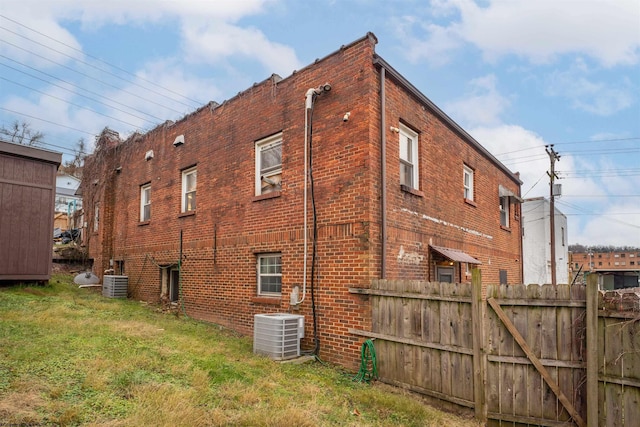 view of home's exterior with a yard and cooling unit