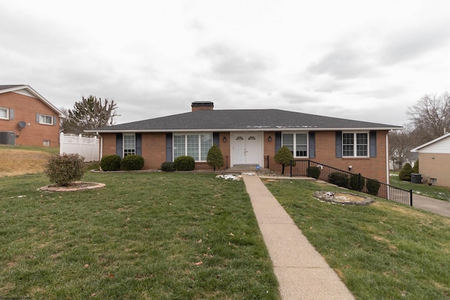 ranch-style home featuring a front yard and central AC