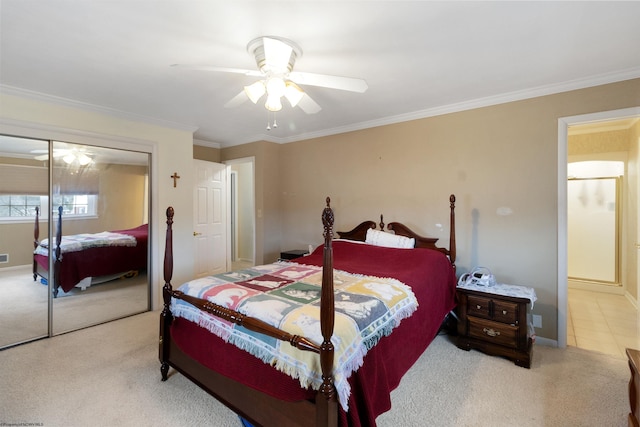 carpeted bedroom with ceiling fan, crown molding, and a closet