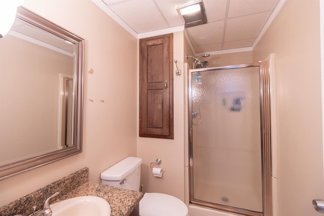 bathroom with a shower with door, vanity, and toilet