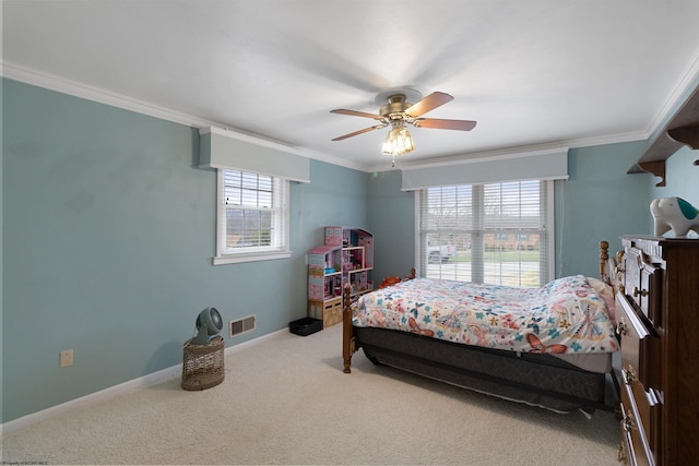 carpeted bedroom featuring ceiling fan and ornamental molding