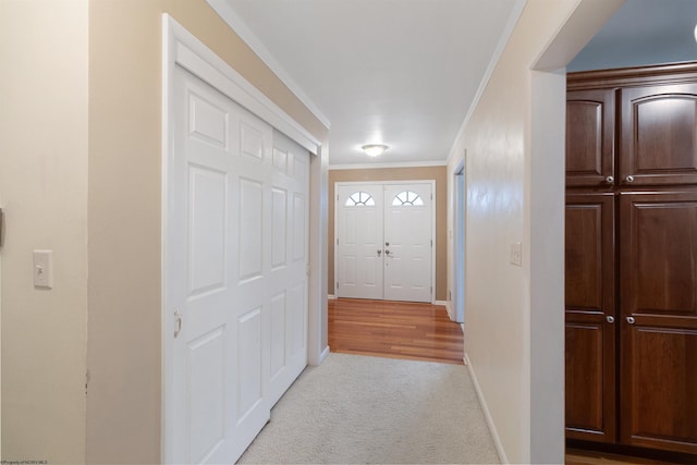 interior space with ornamental molding and light carpet