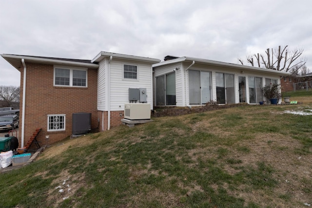 rear view of property featuring a yard