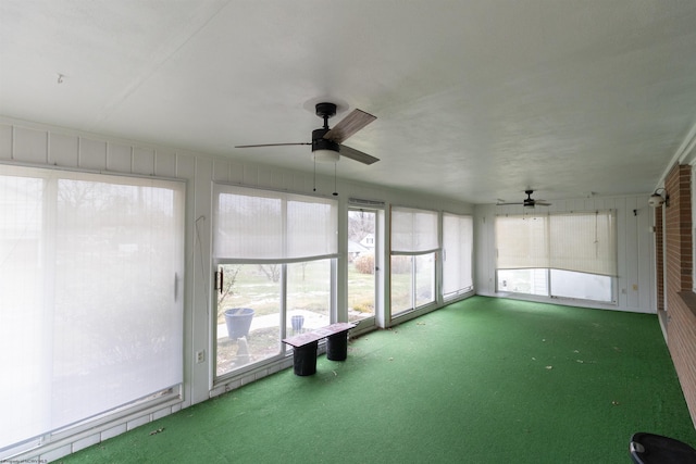 unfurnished sunroom with a wealth of natural light and ceiling fan