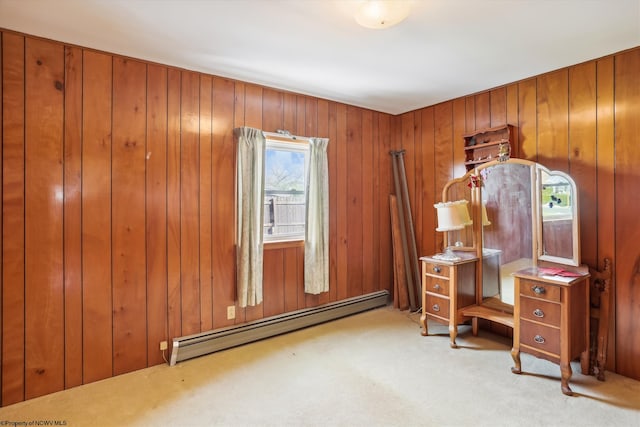 carpeted office with a baseboard radiator and wooden walls