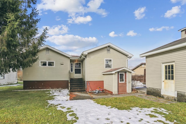 back of house featuring a storage unit and a yard