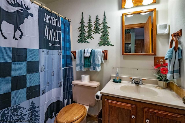 bathroom featuring vanity, a shower with shower curtain, and toilet