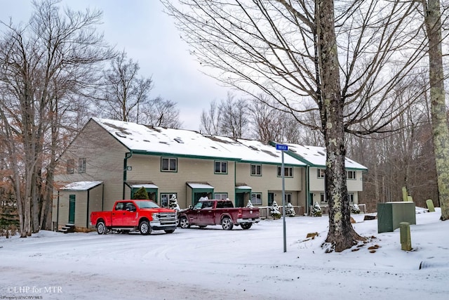 view of snow covered rear of property